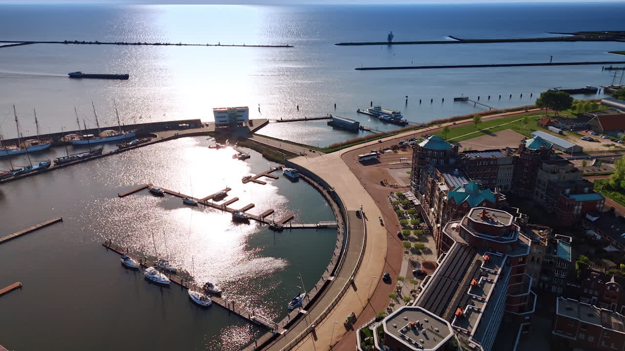 Port with few boats at the piers. Drone footage above Lelystad, Batavialand, the Netherlands on a beautiful sunny day.