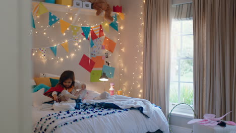 happy-little-girl-jumping-on-bed-wearing-costume-playing-game-enjoying-playful-imagination-in-colorful-bedroom-at-home