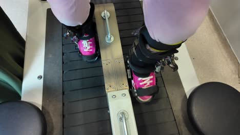 person undergoing gait training on a treadmill with leg braces