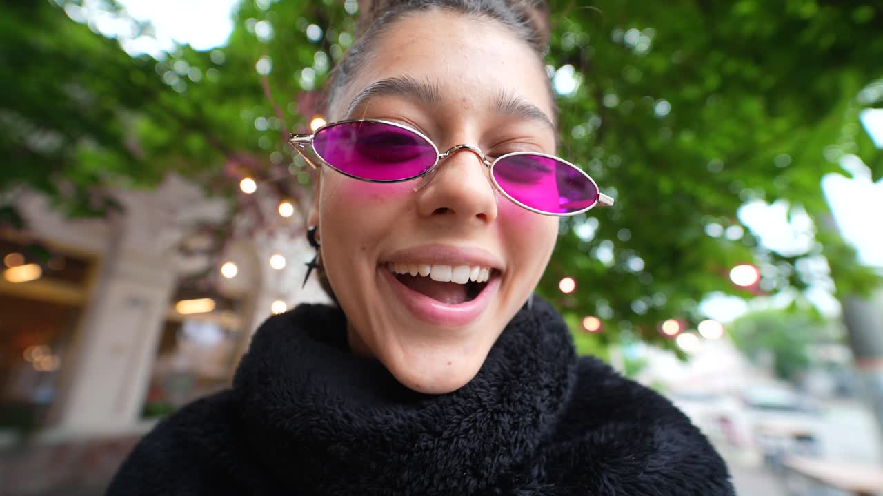 Young Woman with Pink Sunglasses Outdoors