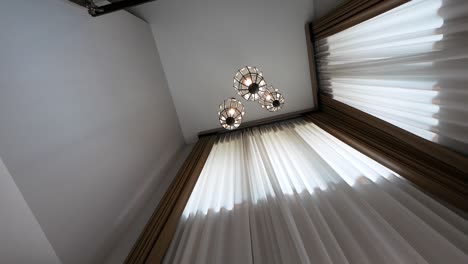 the luxurious crystal chandelier is hanging on the high ceiling
