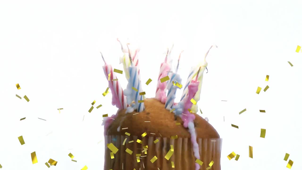 animación de confeti dorado cayendo sobre velas derretidas en un pastel contra un fondo blanco.