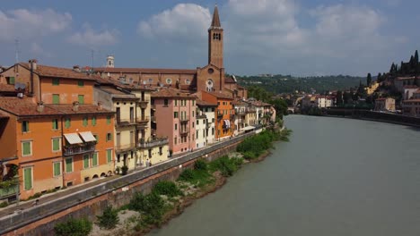Aerial view of typical Italian Street (Lungadige Tullio Donatelli Street) by Adige River with Church in Verona, Italy