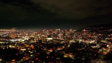 Drone-shot-panning-to-the-left-of-downtown-Salt-Lake-City,-UT-at-night