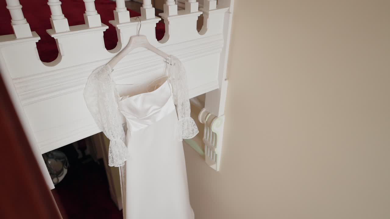 elegant bridal gown displayed on hanger in romantic interior space