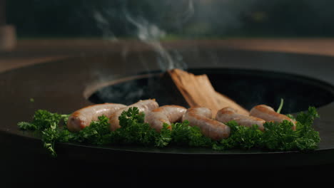 Meat-sausages-browning-on-grill-outdoors.-Food-preparing-for-bbq-party