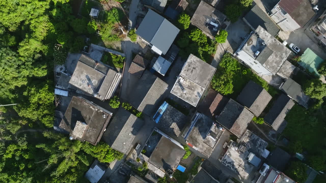 Birds eye aerial view over houses in Xingping Ancient Town, summer day in China