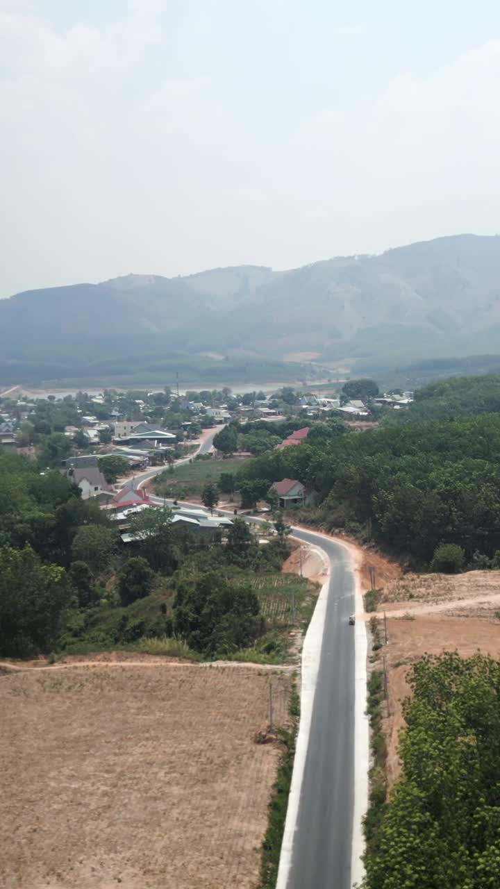 Scenic view of a road through a rural landscape with mountains