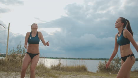 slender sportswomen are playing volleyball on beach slow motion shot of jumping players pass and attack