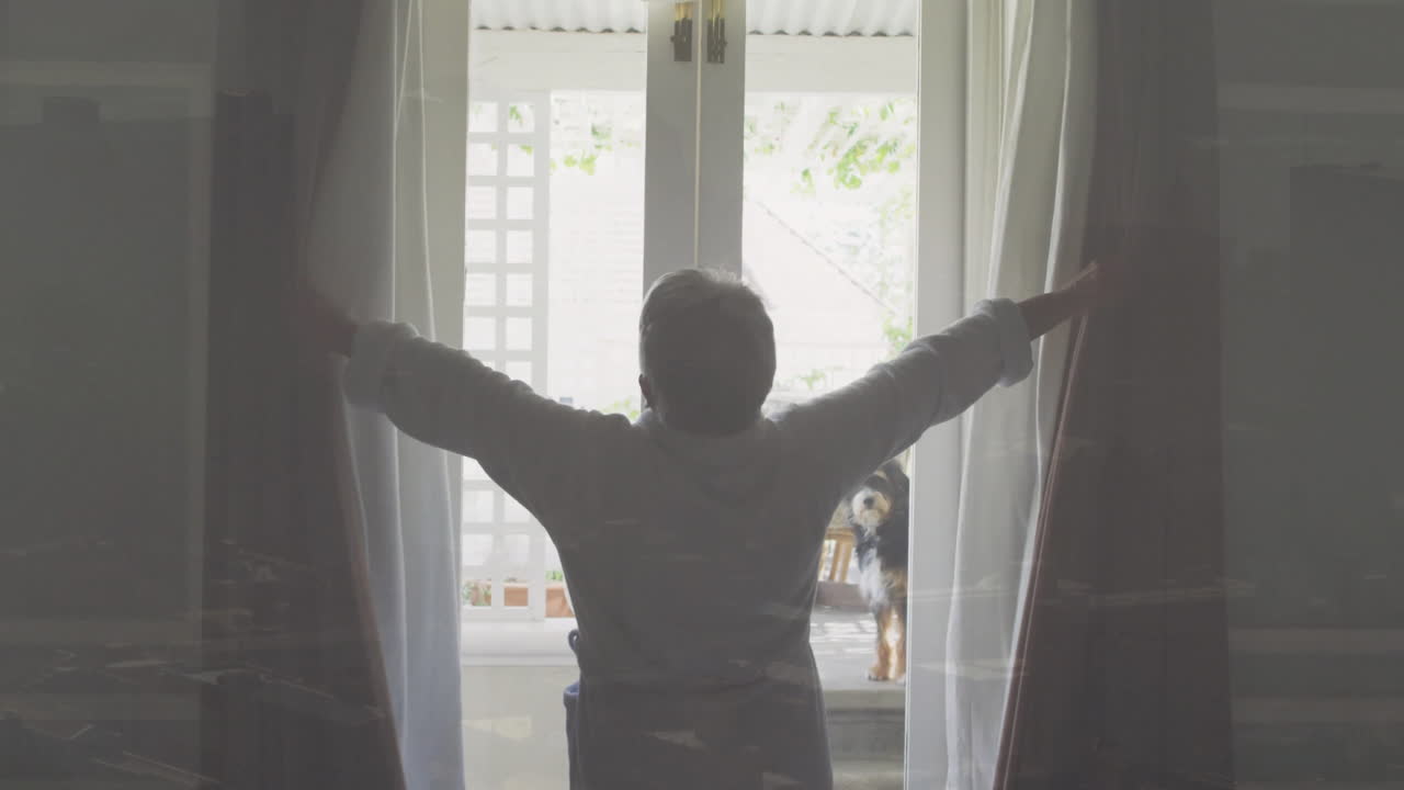 Opening curtains, person welcoming sunlight into bright room with garden view