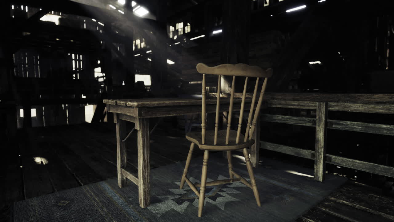 Abandoned wooden chair and table in a dimly lit barn during the day