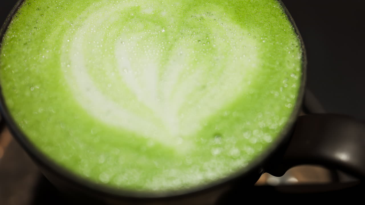 Close up of a matcha latte on a tray at a cafe