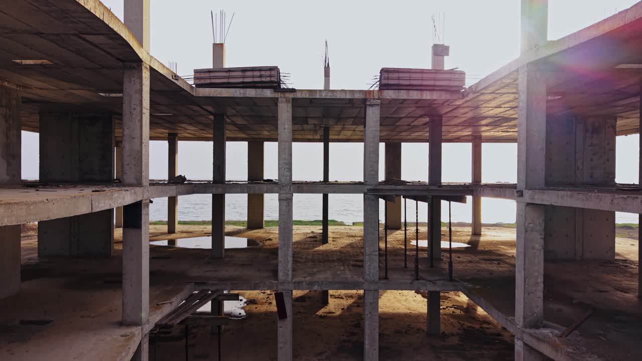 Exploring an abandoned structure by the seaside at sunset