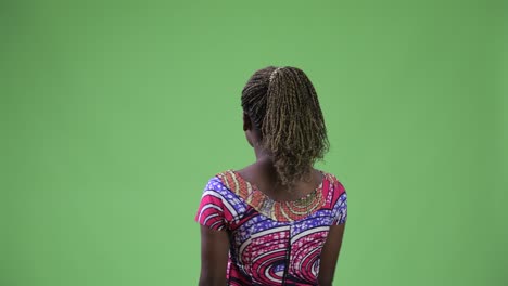 rear view of young african woman pointing finger