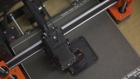 Top-shot,-3D-printer-prints-black-square-in-the-laboratory