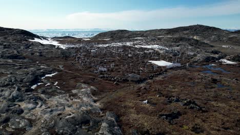 Dramatic-aerial-overview-of-graveyard-and-white-crosses,-ice-fjord