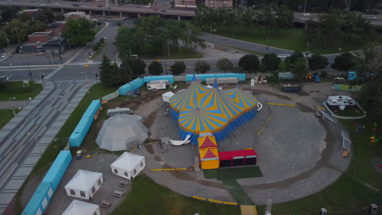 Aerial pan over yellow blue carnival circus tent