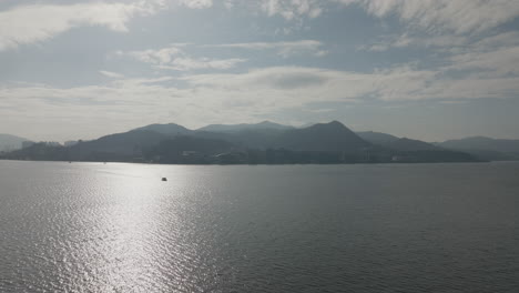 Drone-shot-of-vast-ocean-with-mountains-in-Hong-Kong