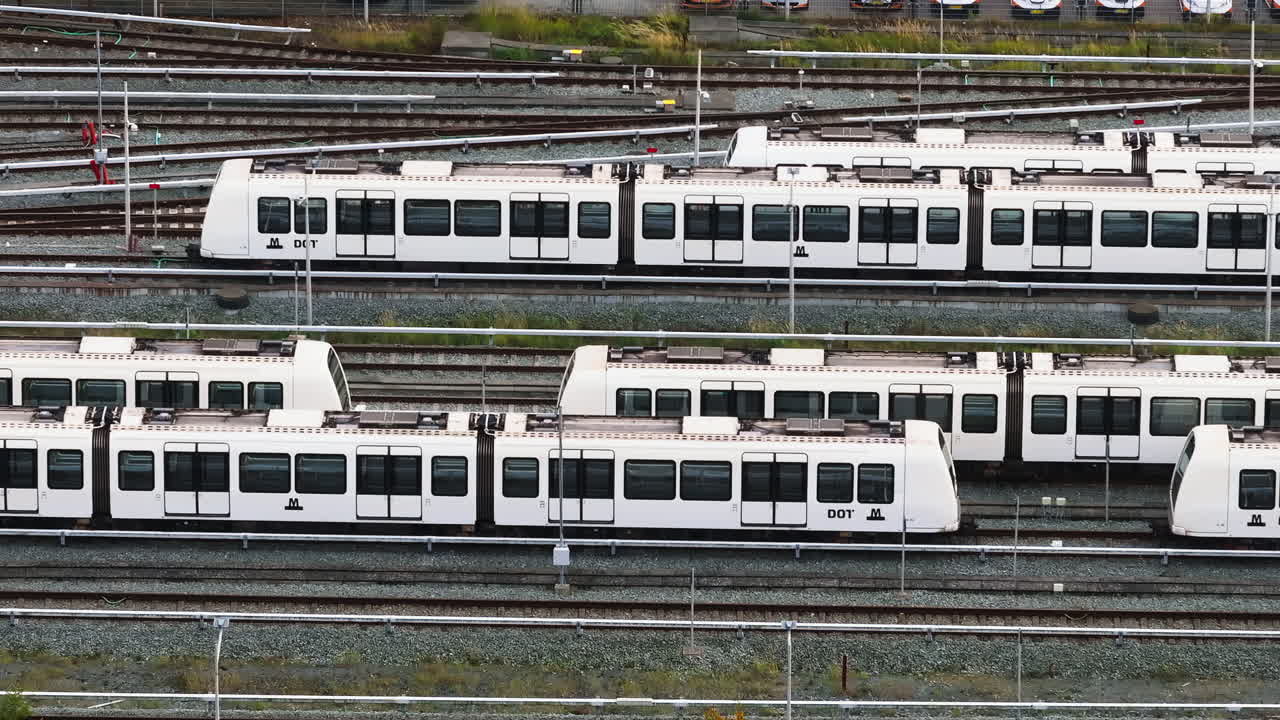 Aerial drone view of white trains on the tracks at the Vesterbro railway station in Copenhagen, Denmark