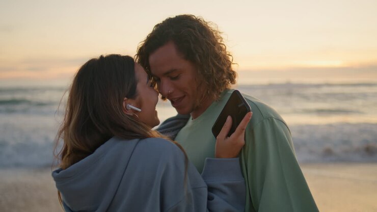 Couple enjoying a sunset on the beach