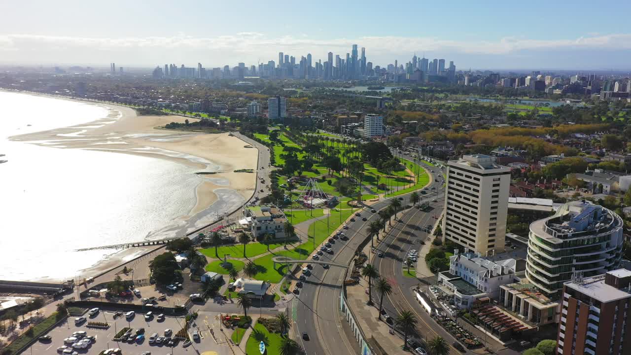 Ascending aerial footage of St Kilda, with Melbourne's CBD in the horizon