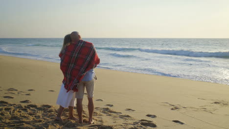 Couple-hugging-and-kissing-on-beach