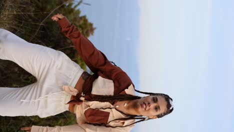 stylish woman dancing in countryside