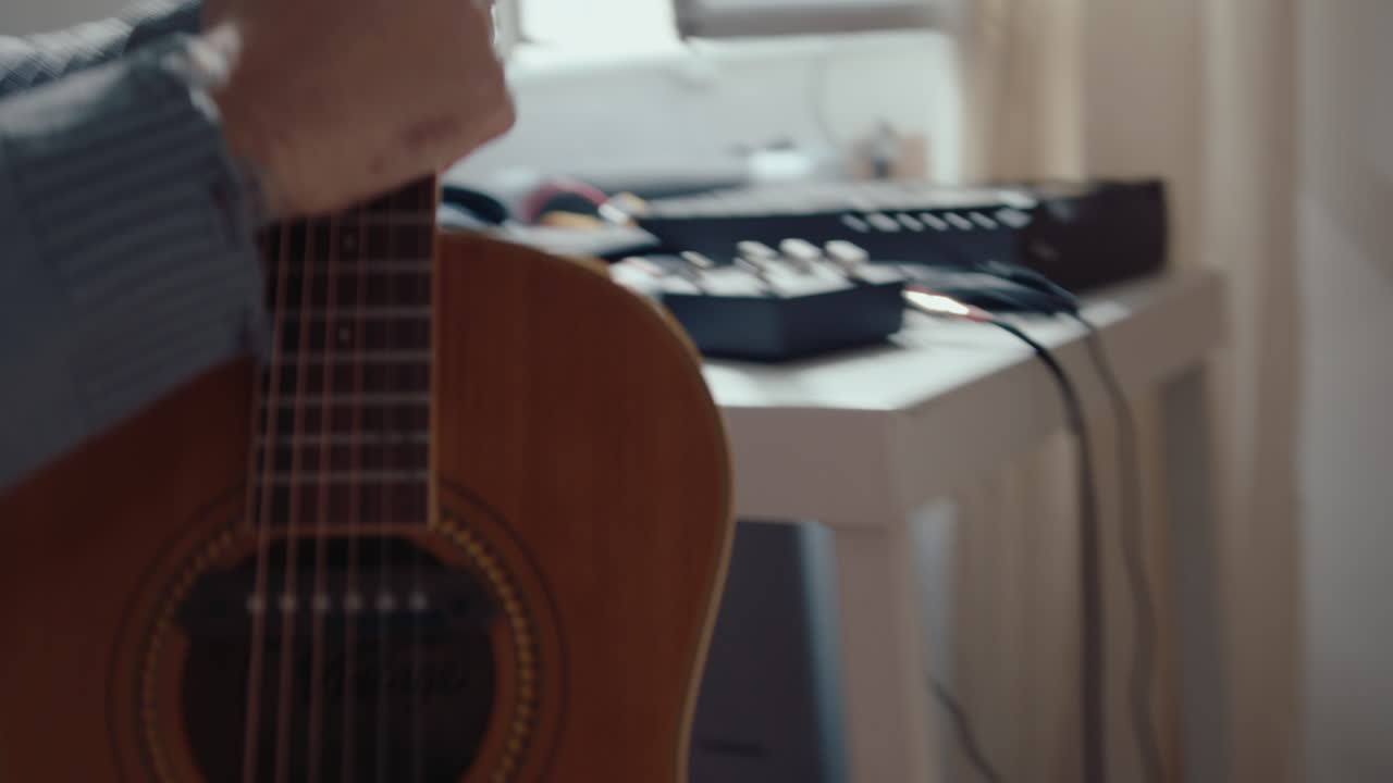 Musician Playing Guitar at Home Recording Studio