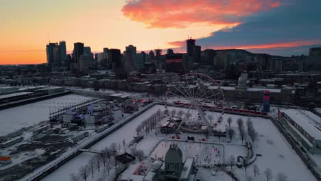 aerial shot around montreal city ferris wheel in the old port at sunset during winter, montreal city, quebec region, canada