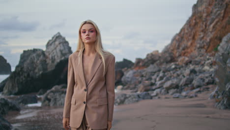 fashionable girl walking coastline in stylish suit. beautiful thoughtful lady