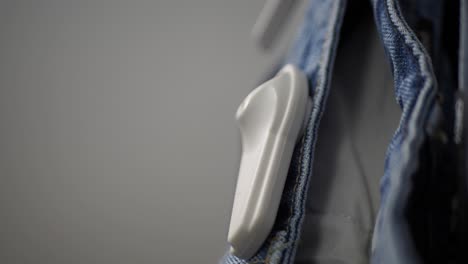 closeup of a security tag attached to a pair of jeans