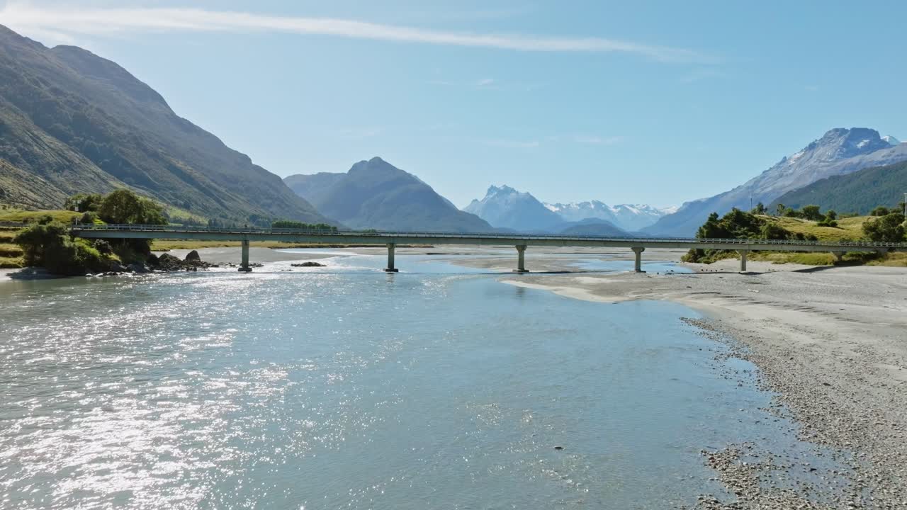 Fast aerial flight over scenic, shallow and winding Dart River Te Awa Whakatipu braided river system with the rugged Southern Alps mountains in Glenorchy, South Island of New Zealand Aotearoa
