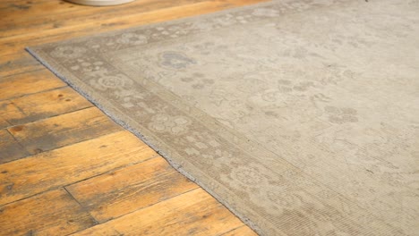 beige vintage rug on wooden floor