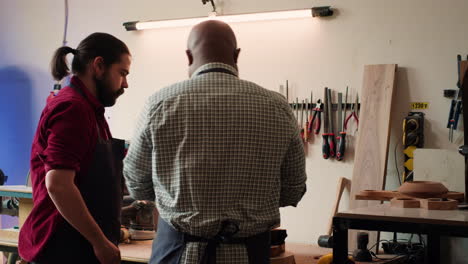 craftsperson doing quality assurance on lumber pile with coworker