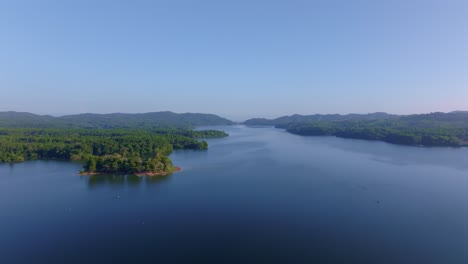 rincon dam and lake in exotic and tropical landscape of dominican republic. sunny day with green mountains. aerial wide shot. forward shot.