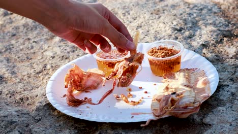 eating fried squid at a street vendor