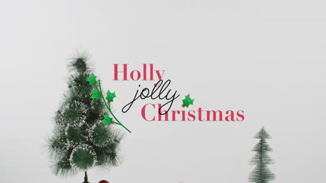 Animation of holly christmas text over fir tree