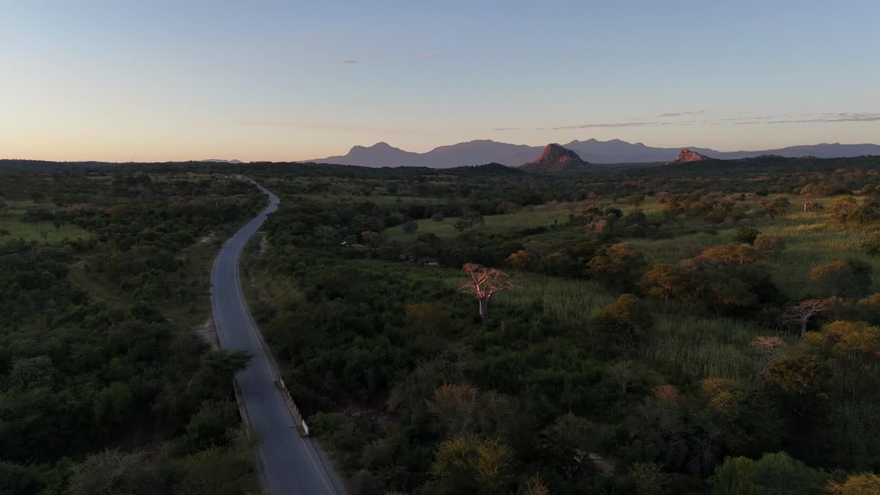 Drone aerial of a lonely road crossing vast countryside near Lubango, Angola