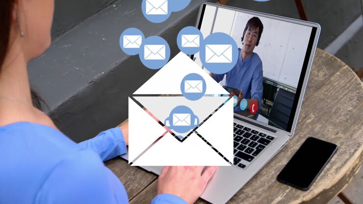 Animation of envelope mail icons over woman using laptop on video call