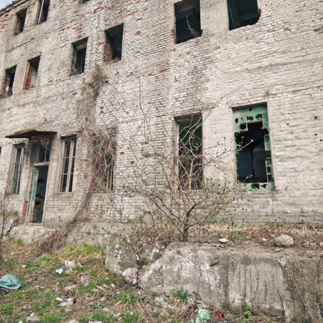 old industrial building for demolition. large ruined abandoned factory hangar or warehouse.