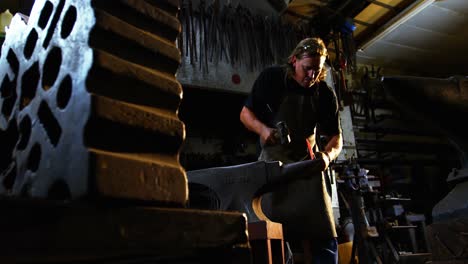 blacksmith working on a iron rod