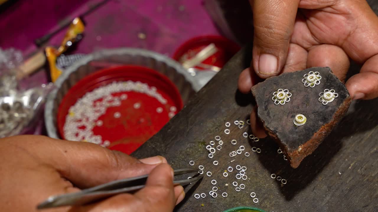 Silversmith's hands at work in famous Celuk village in Bali, Indonesia, close up shot