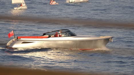 a sleek motorboat glides across the waters near monte carlo, monaco, capturing a scene of luxury, relaxation, and modern elegance. the allure of yachting along the mediterranean coast.