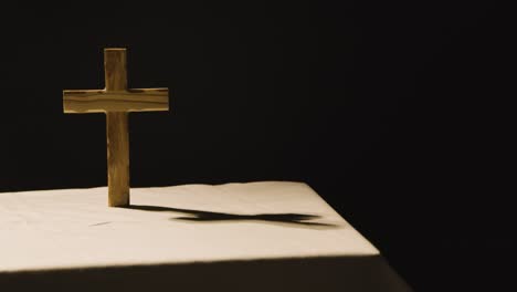 religious concept shot with wooden cross on altar in pool of light 1