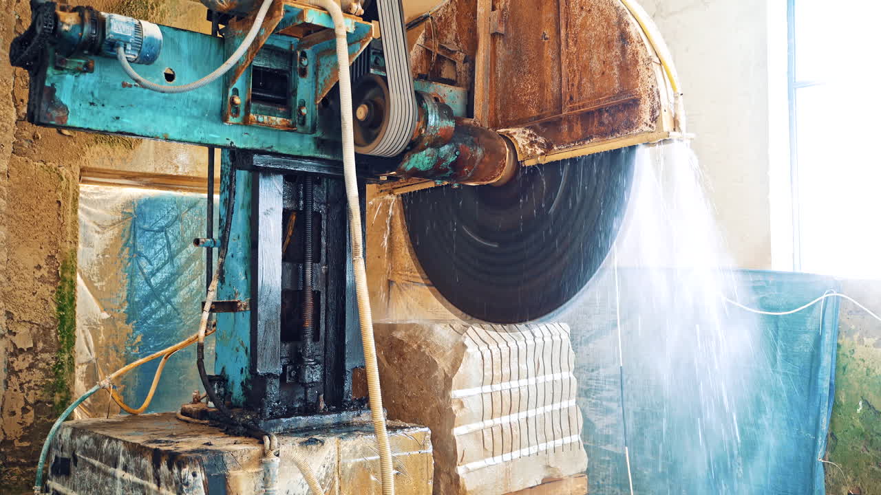 Industrial marble cutting factory. Marble cooled with water while cutting at factory
