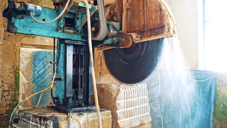 industrial marble cutting factory. marble cooled with water while cutting at factory