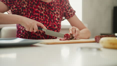 woman cutting sausage