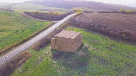Straw-pile-aerial-orbit-shot-in-the-countryside
