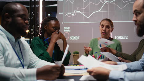 diverse project team shares analytics reports during advisory board event