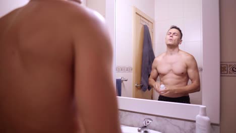 man grooming in bathroom mirror
